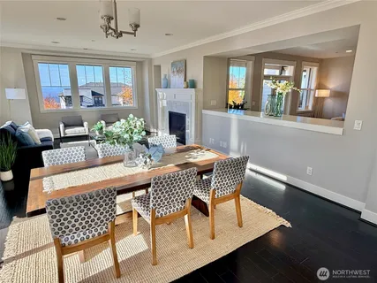 a dining room with furniture a rug and wooden floor