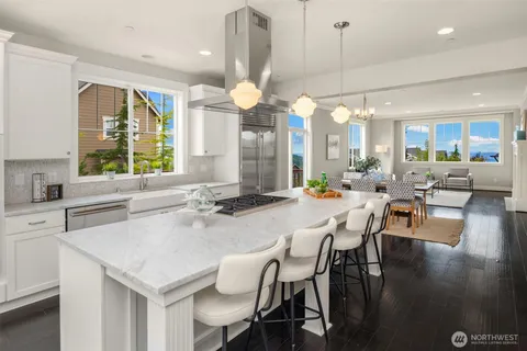a large kitchen with a table and chairs