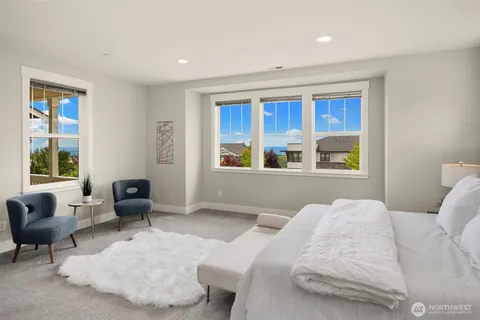 a bathroom with a granite countertop sink and large window