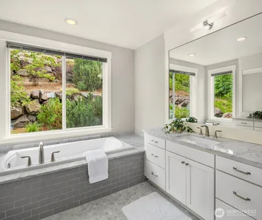 a bathroom with a shower sink and mirror