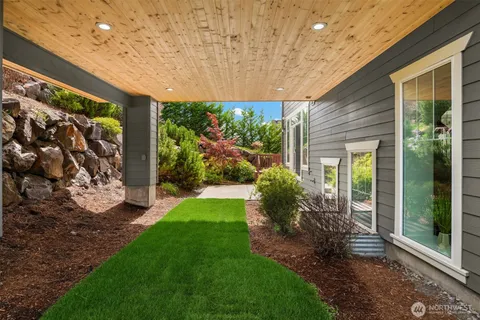 a view of a house with a patio and a yard