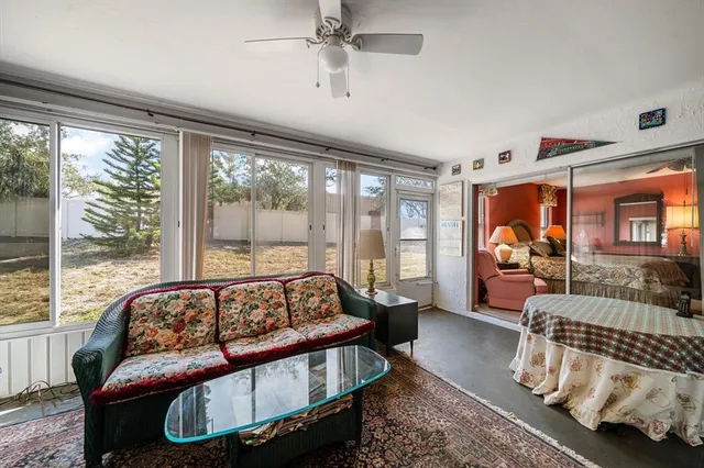 a bedroom with furniture and a large window