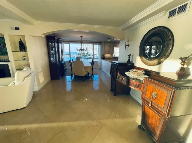 a living room with furniture a rug and a large window