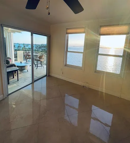 a living room with furniture and a floor to ceiling window