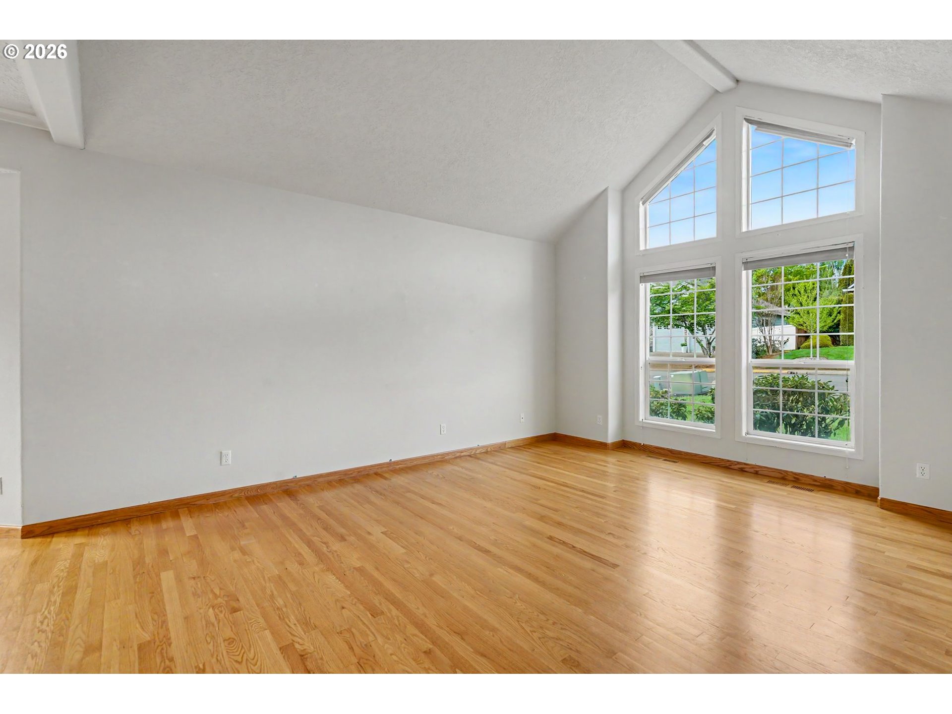 1470 Ranier Loop Northwest Salem, OR 97304 - Photo 7 of 48 a view of an empty room with wooden floor and a window