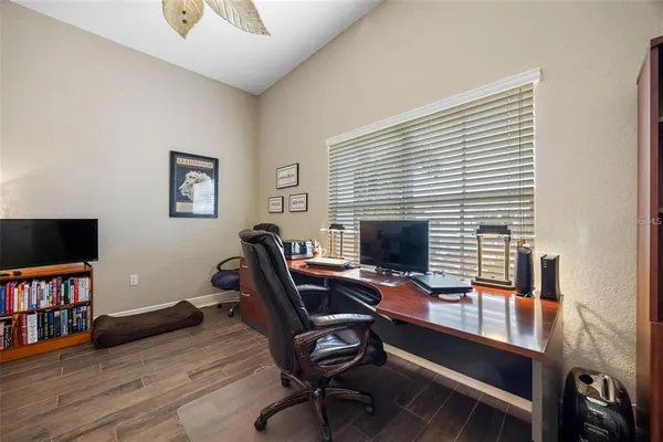a view of a workspace with furniture and a window