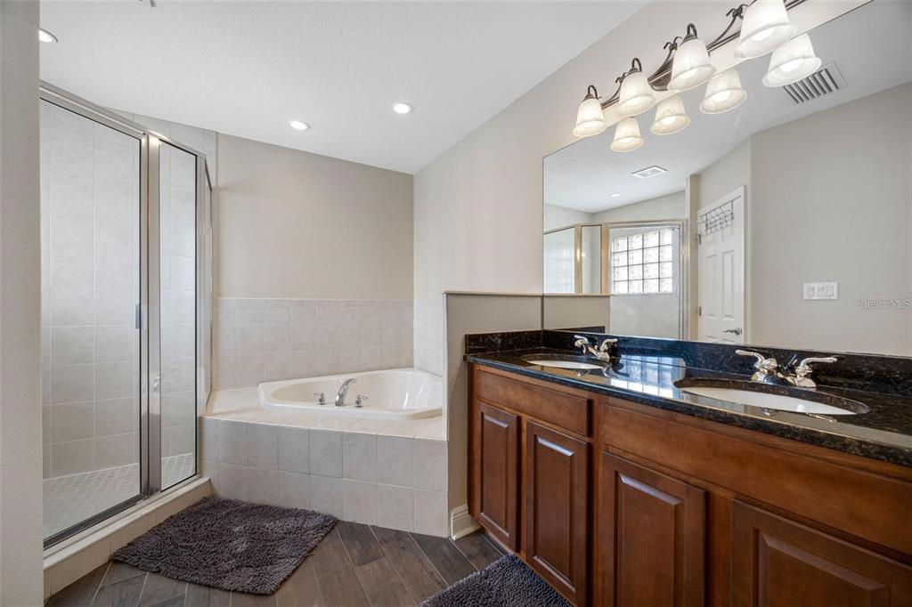 146 175th Terrace Drive East Redington Shores, FL 33708 - Photo 21 of 51 a bathroom with a double vanity sink a mirror and a bathtub