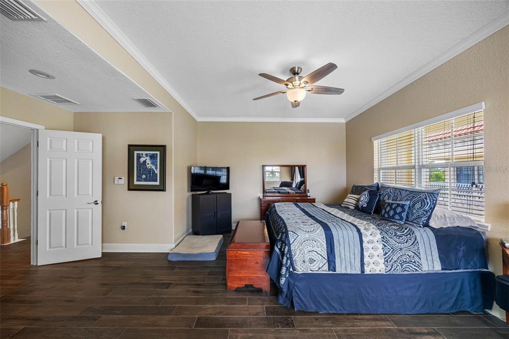 146 175th Terrace Drive East Redington Shores, FL 33708 - Photo 25 of 51 a bedroom with furniture and wooden floor