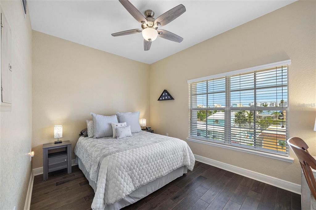 146 175th Terrace Drive East Redington Shores, FL 33708 - Photo 30 of 51 a bedroom with a large bed and a large window