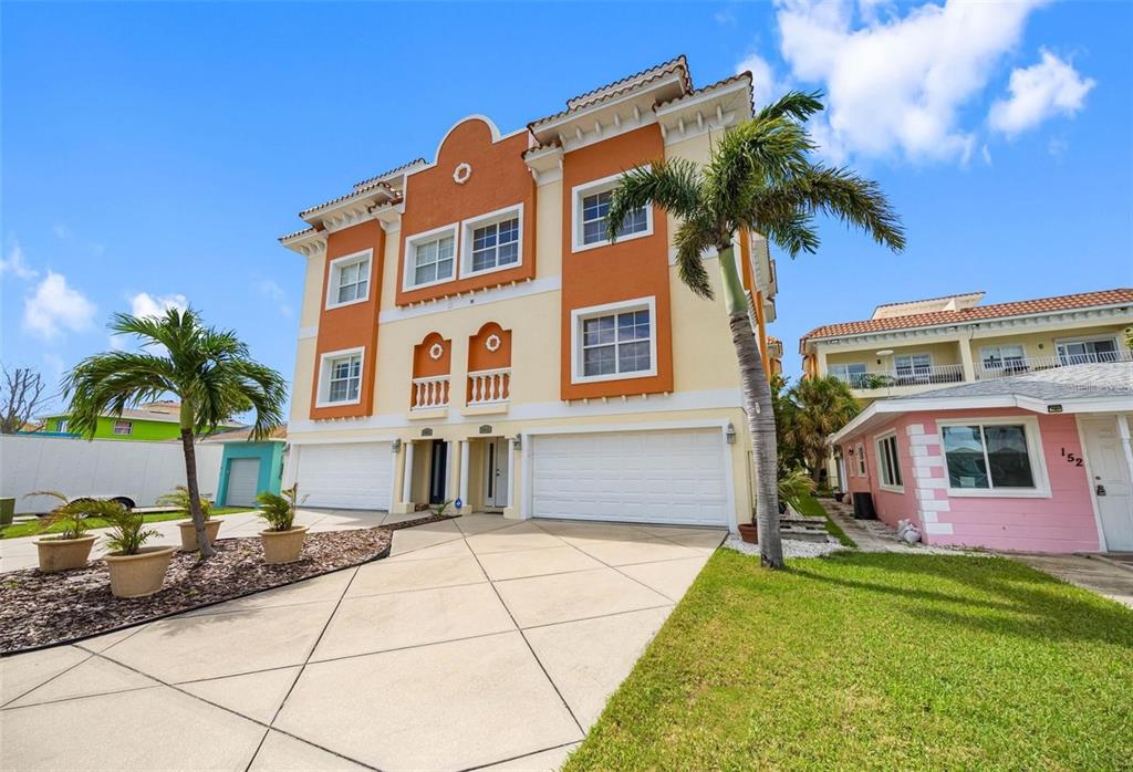 146 175th Terrace Drive East Redington Shores, FL 33708 - Photo 4 of 51 a front view of a house with a garden