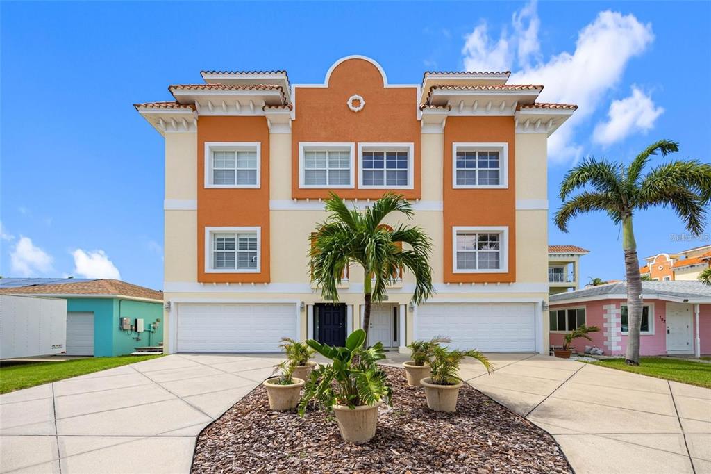 146 175th Terrace Drive East Redington Shores, FL 33708 - Photo 44 of 51 a front view of a house with a yard and garage