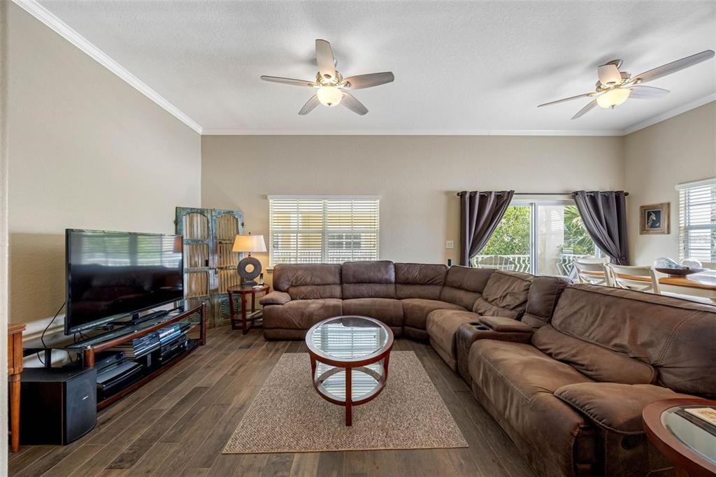 146 175th Terrace Drive East Redington Shores, FL 33708 - Photo 6 of 51 a living room with furniture a flat screen tv and a window