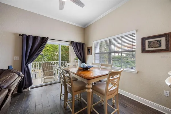 a kitchen with stainless steel appliances granite countertop a sink a stove a refrigerator cabinets and chairs