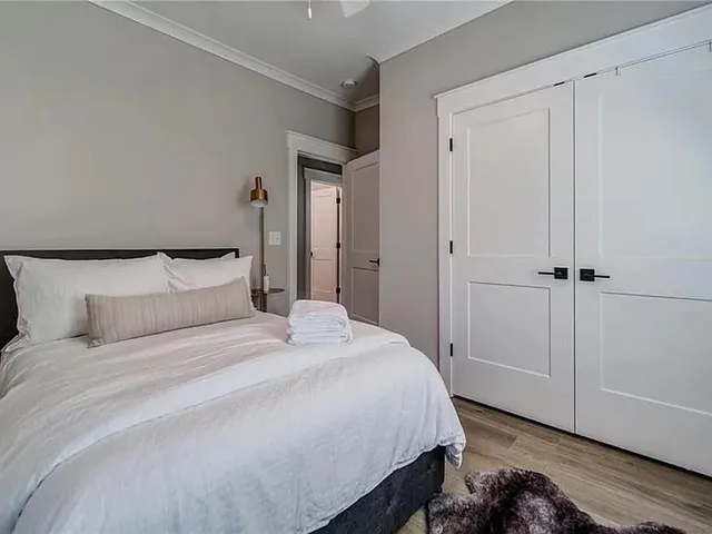 a bedroom with a bed and a closet