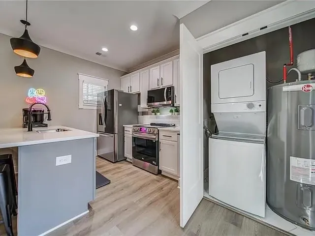 a kitchen with kitchen island a refrigerator stove and sink