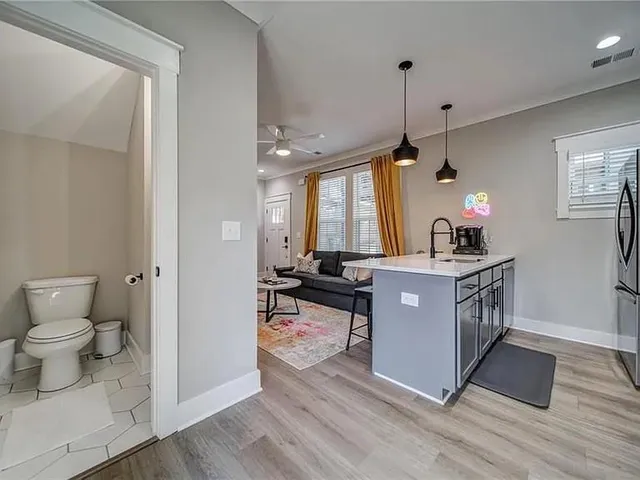 a kitchen with a sink cabinets and wooden floor
