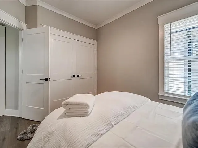 a bedroom with a bed and a window