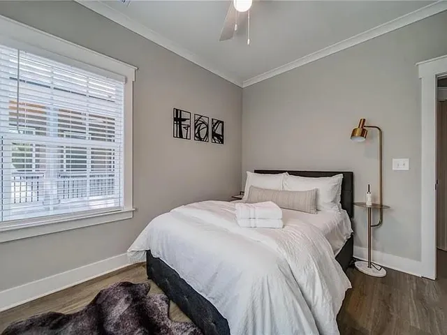 a bedroom with a bed and a window