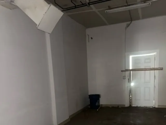 a view of a kitchen with wooden cabinets