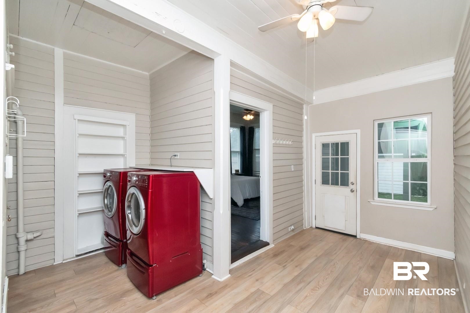1305 Brown Street Mobile, AL 36604 - Photo 20 of 37 Laundry room featuring light hardwood / wood-style floors, ornamental molding, wooden walls, and separate washer and dryer