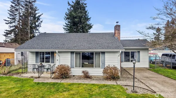 a front view of a house with garden and patio