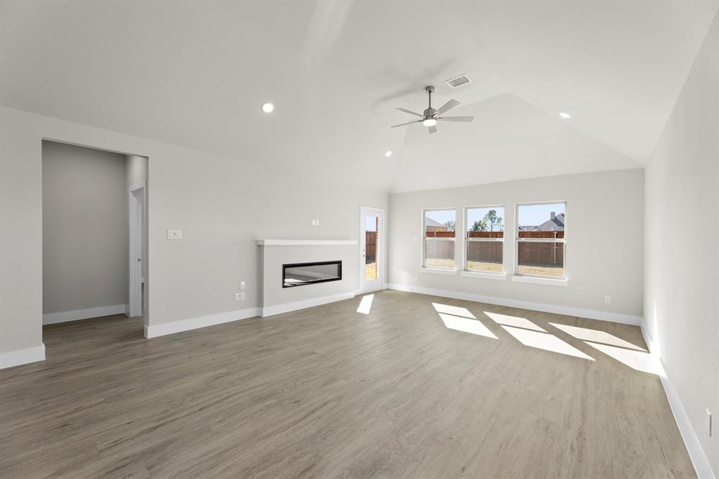 2359 Bell Way Forney, TX 75126 - Photo 17 of 31 an empty room with wooden floor and ceiling fan