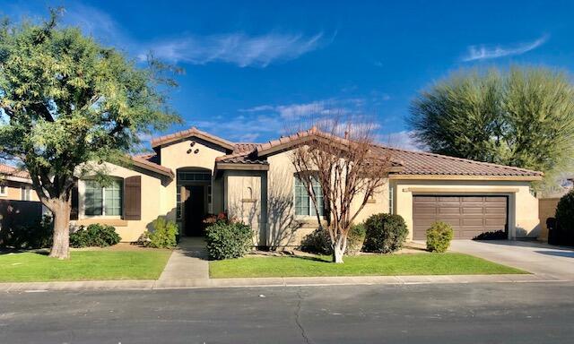 83346 Lone Star Road Indio, CA 92203 - Photo 1 of 12 a front view of a house with a yard and trees