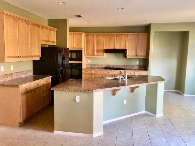 83346 Lone Star Road Indio, CA 92203 - Photo 2 of 12 a kitchen with stainless steel appliances granite countertop a stove a refrigerator a sink and dishwasher