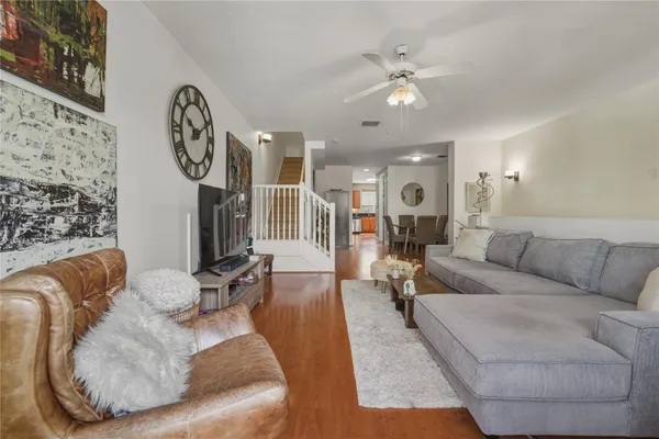a living room with furniture and kitchen view