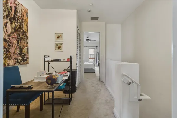 a view of a workspace with furniture and wooden floor