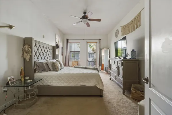a bedroom with a bed mirror and window