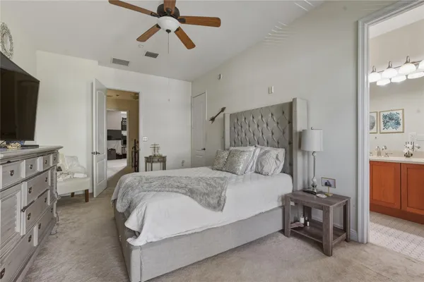 a bedroom with a bed and a tv on the dresser