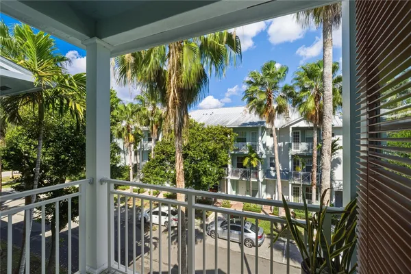 a view of a balcony with flower plants