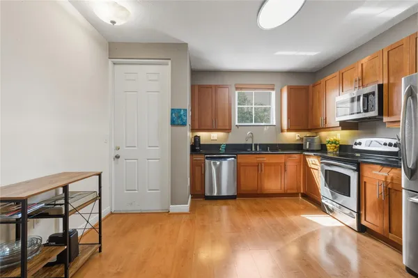 a kitchen with granite countertop a stove top oven a sink and dishwasher with a dishwasher