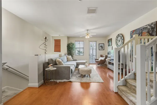 a living room with furniture window and wooden floor