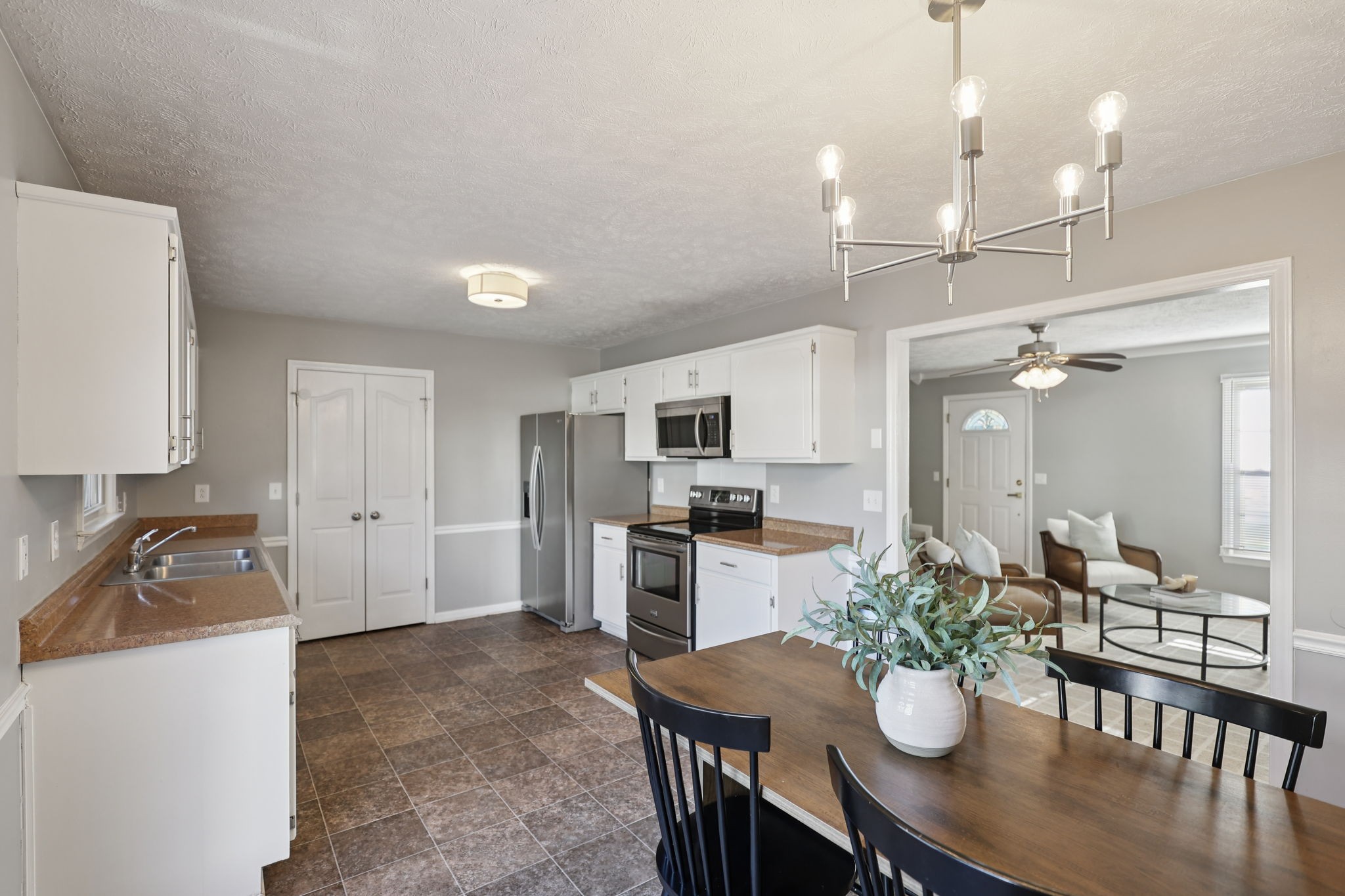 403 Acorn Court Smyrna, TN 37167 - Photo 11 of 34 a kitchen with sink a refrigerator and chairs