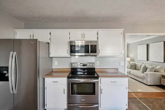 a kitchen with stainless steel appliances a stove a microwave and a refrigerator