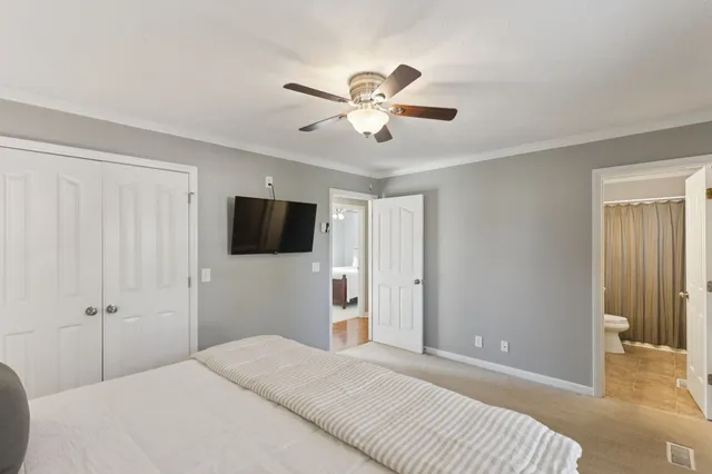 a bedroom with a bed and a flat screen tv