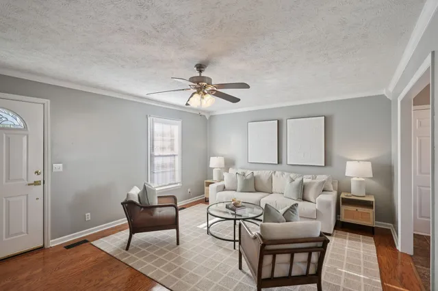 a living room with furniture and a chandelier