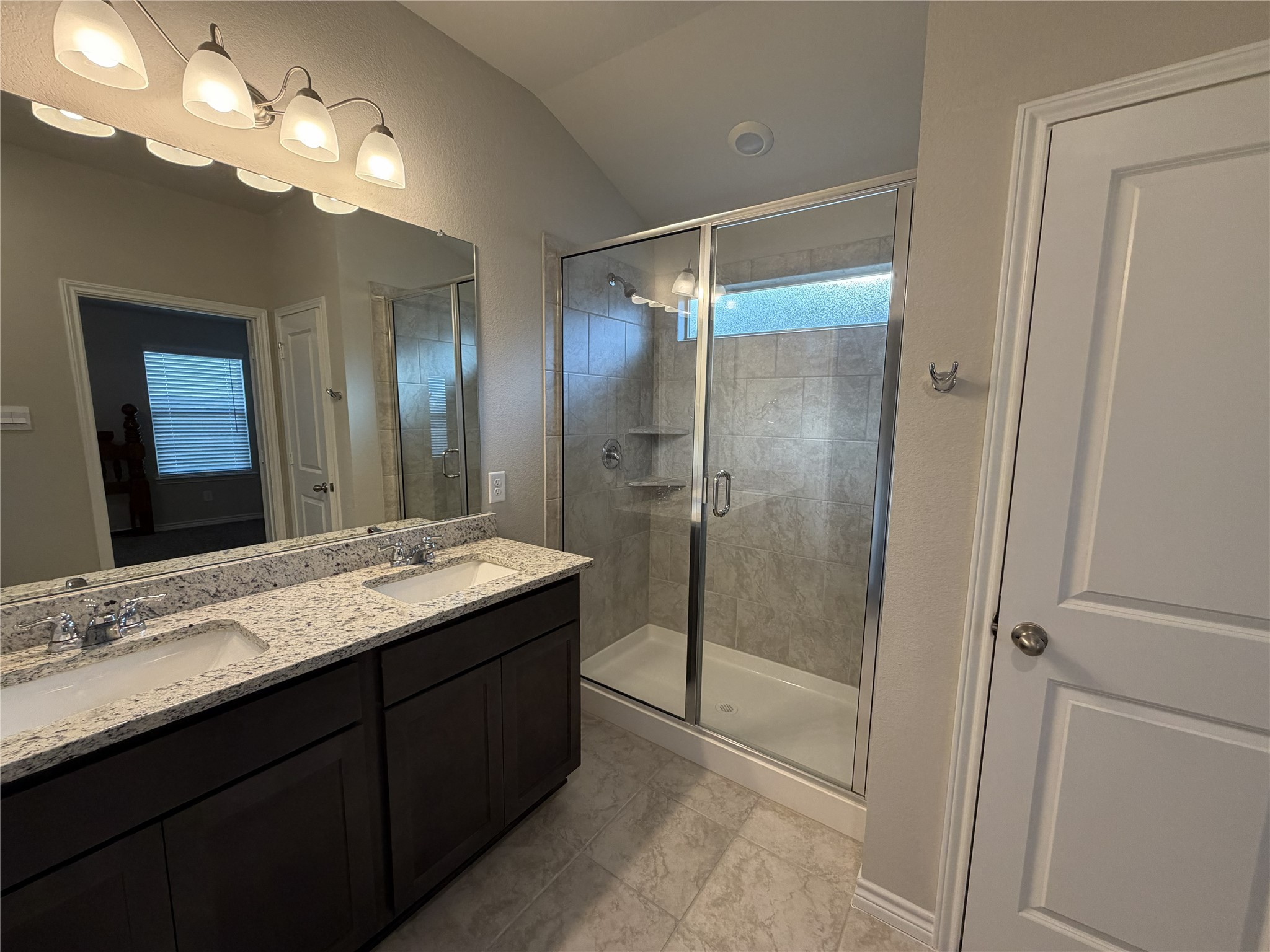 610 Legrand Street Brenham, TX 77833 - Photo 5 of 14 a bathroom with a granite countertop sink mirror and shower