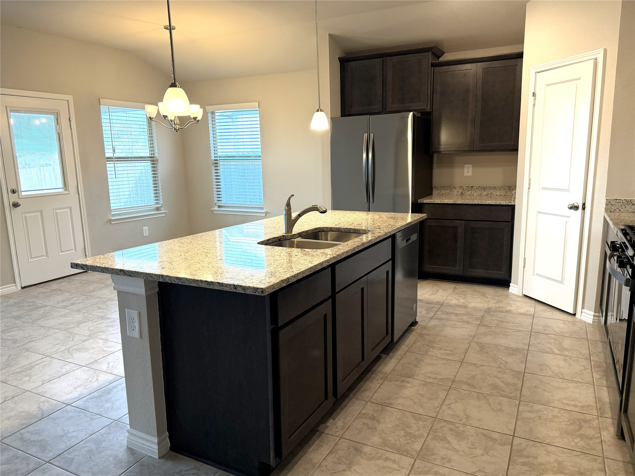 610 Legrand Street Brenham, TX 77833 - Photo 8 of 14 a kitchen with a sink refrigerator and cabinets