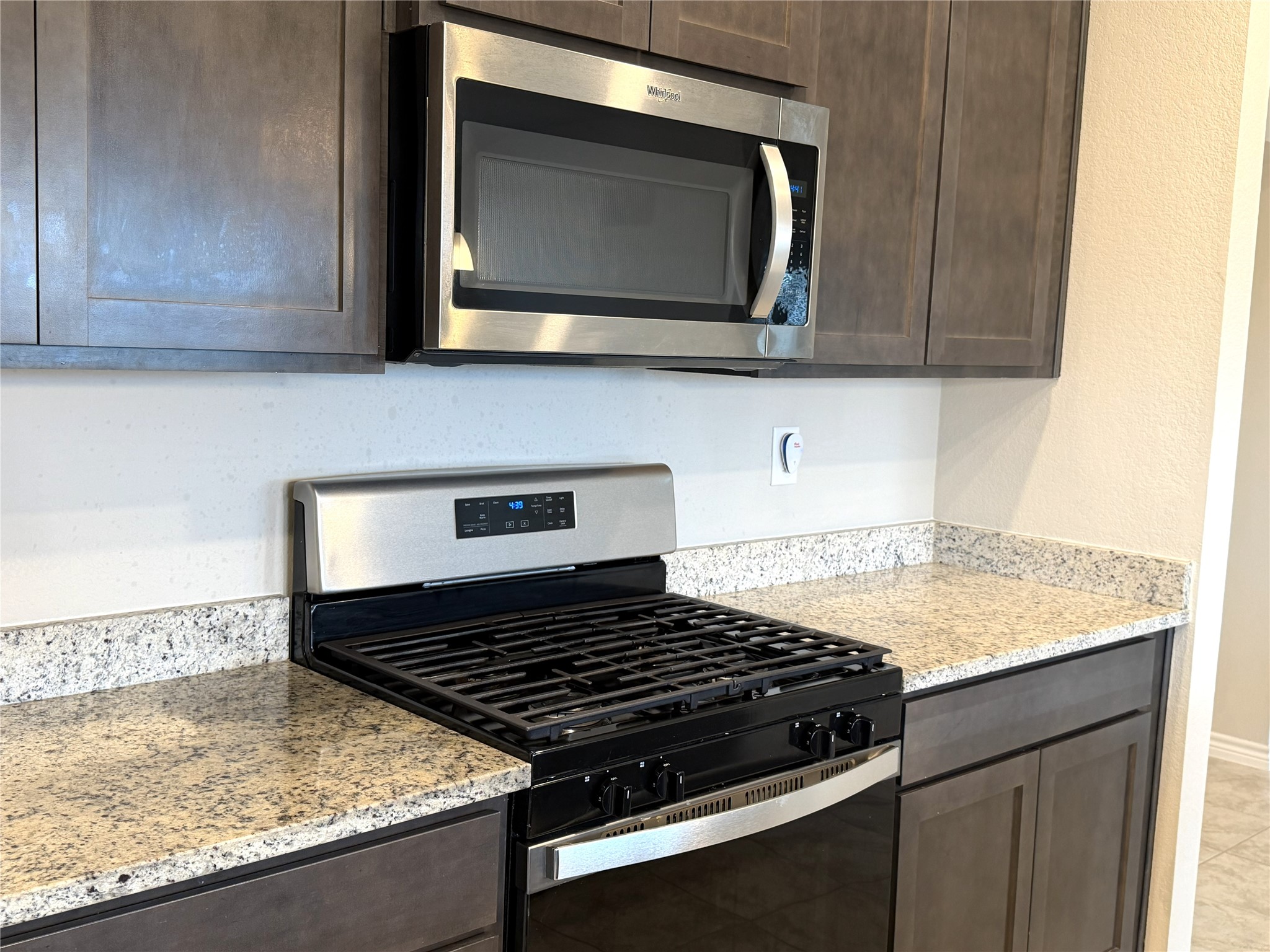 610 Legrand Street Brenham, TX 77833 - Photo 10 of 14 a kitchen with granite countertop a stove and a microwave