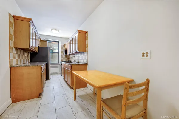 a kitchen with stainless steel appliances kitchen island granite countertop a refrigerator and a stove top oven