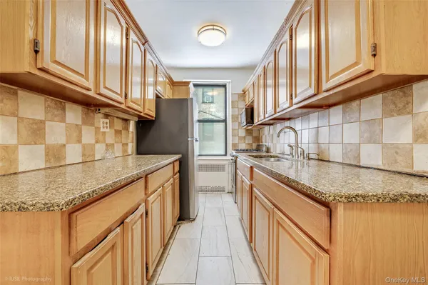 a kitchen with stainless steel appliances granite countertop a sink and cabinets