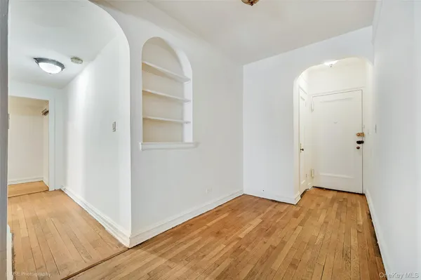 an empty room with wooden floor and closet
