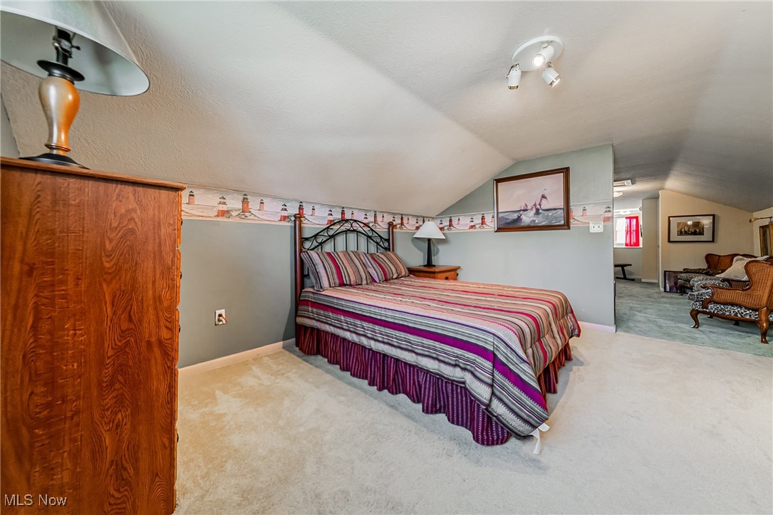 1104 Waverly Road Sandusky, OH 44870 - Photo 25 of 46 Carpeted bedroom with vaulted ceiling