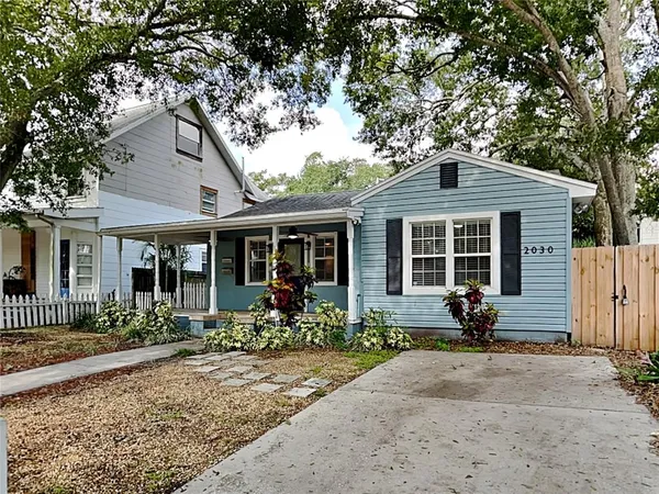 a front view of a house with a garden and porch