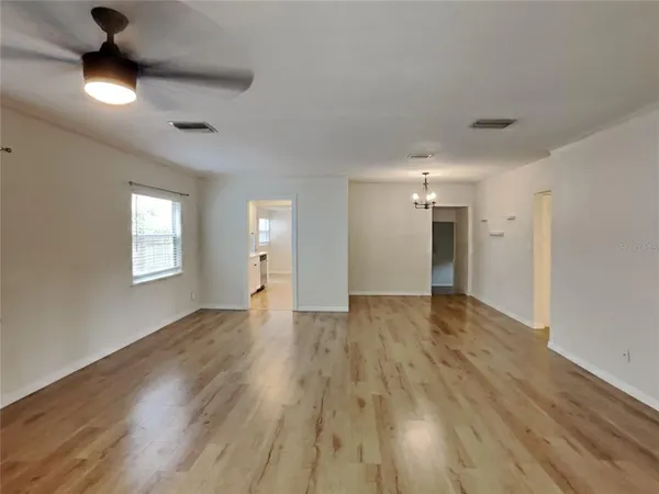 a view of an empty room and wooden floor