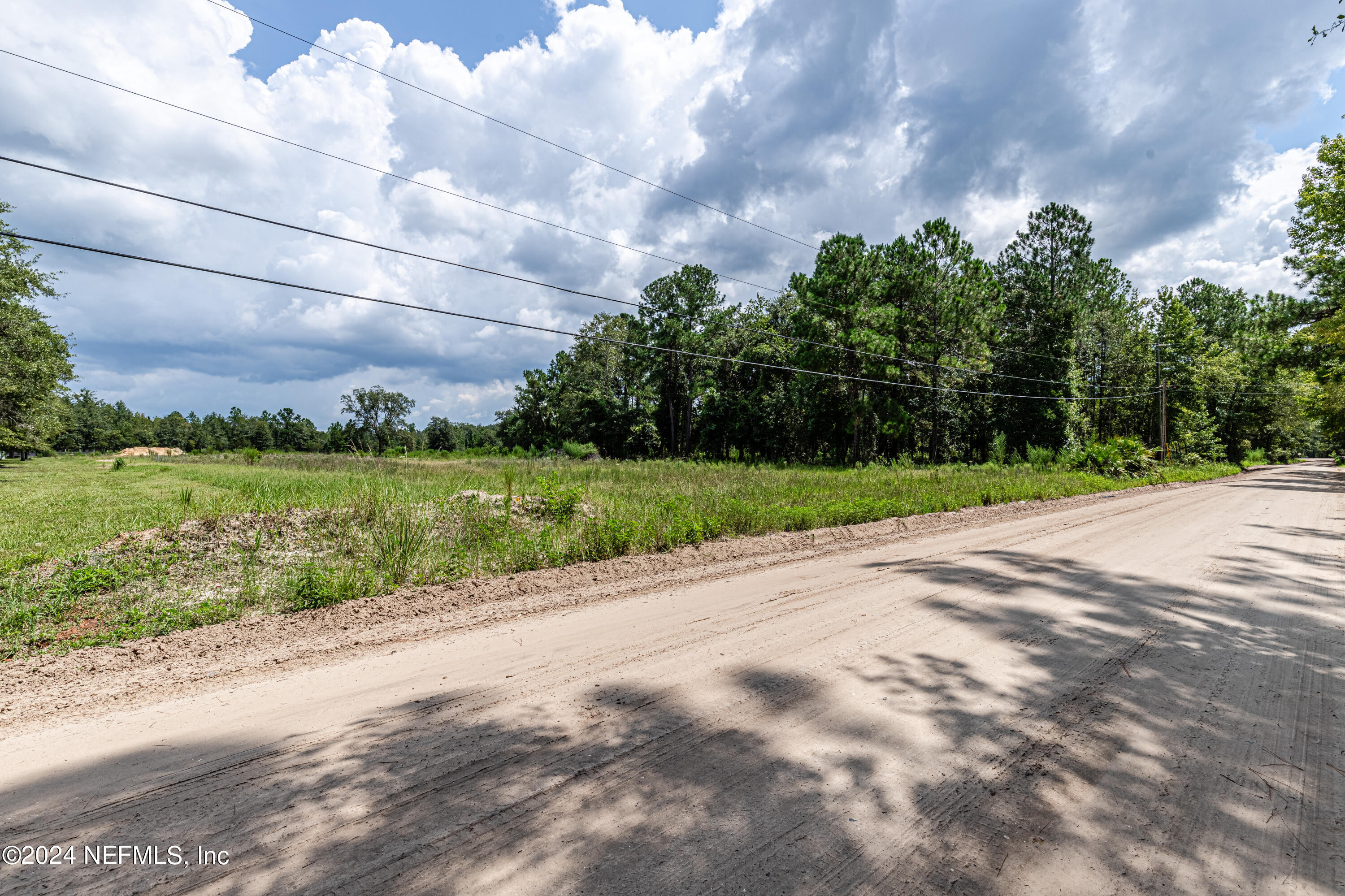 5570 Long Branch Road Jacksonville, FL 32234 - Photo 3 of 8 a view of a lake with a big yard