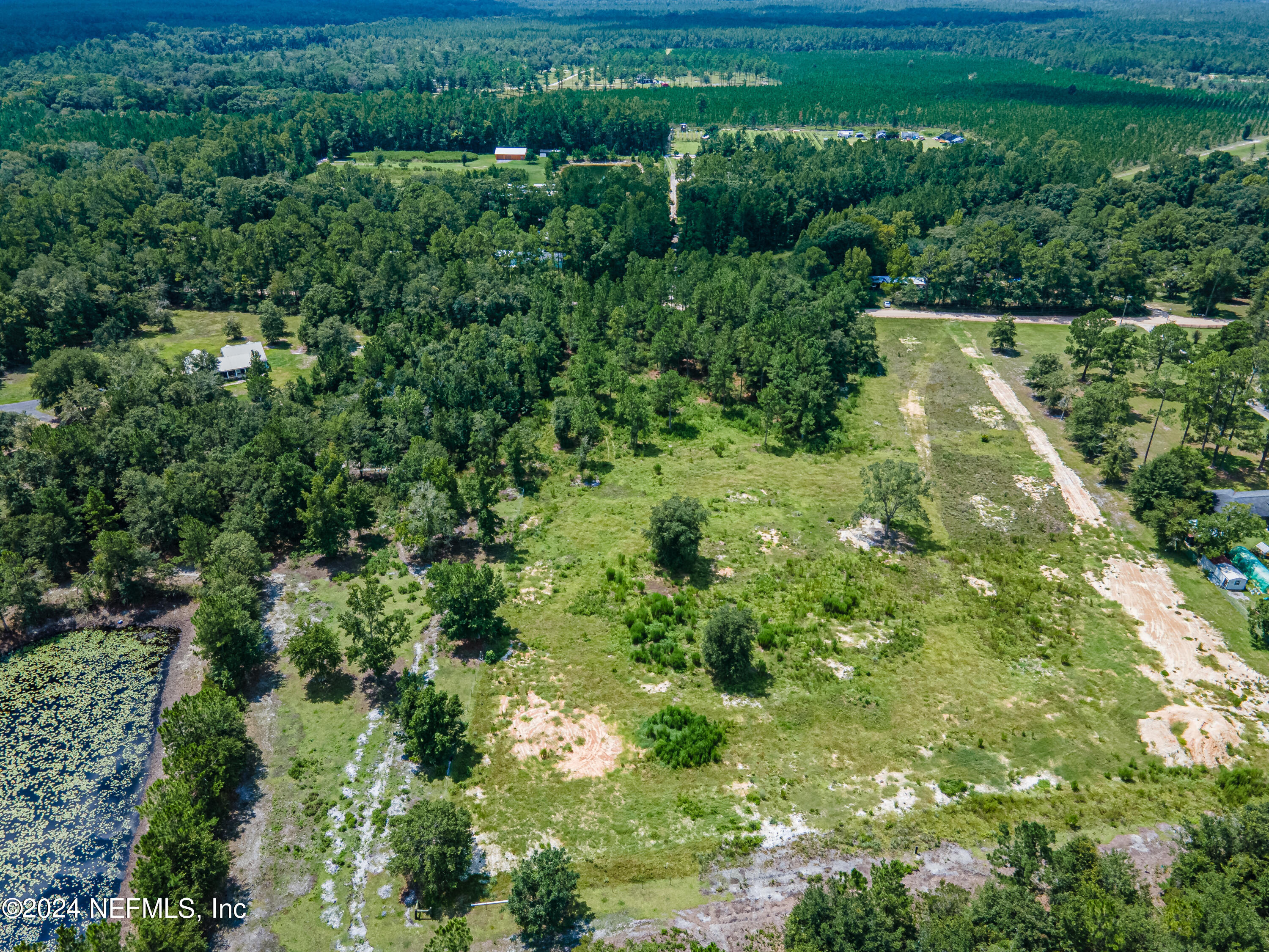 5570 Long Branch Road Jacksonville, FL 32234 - Photo 6 of 8 an aerial view of residential houses with outdoor space and trees